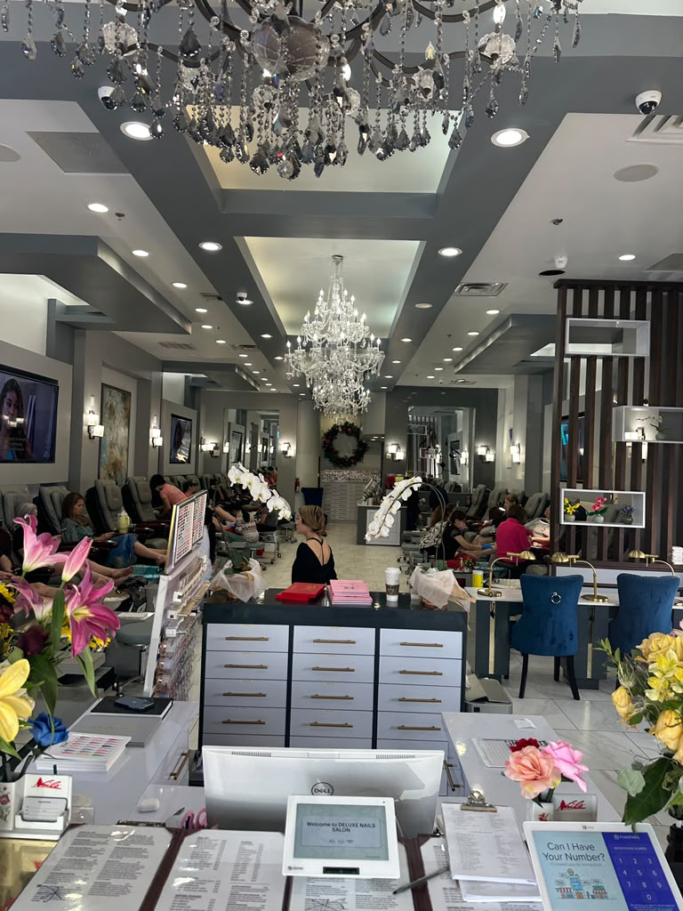 Deluxe Nails Salon interior with crystal chandeliers and white orchids